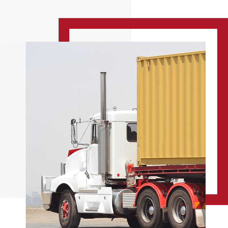 A white semi truck with a yellow trailer behind it.